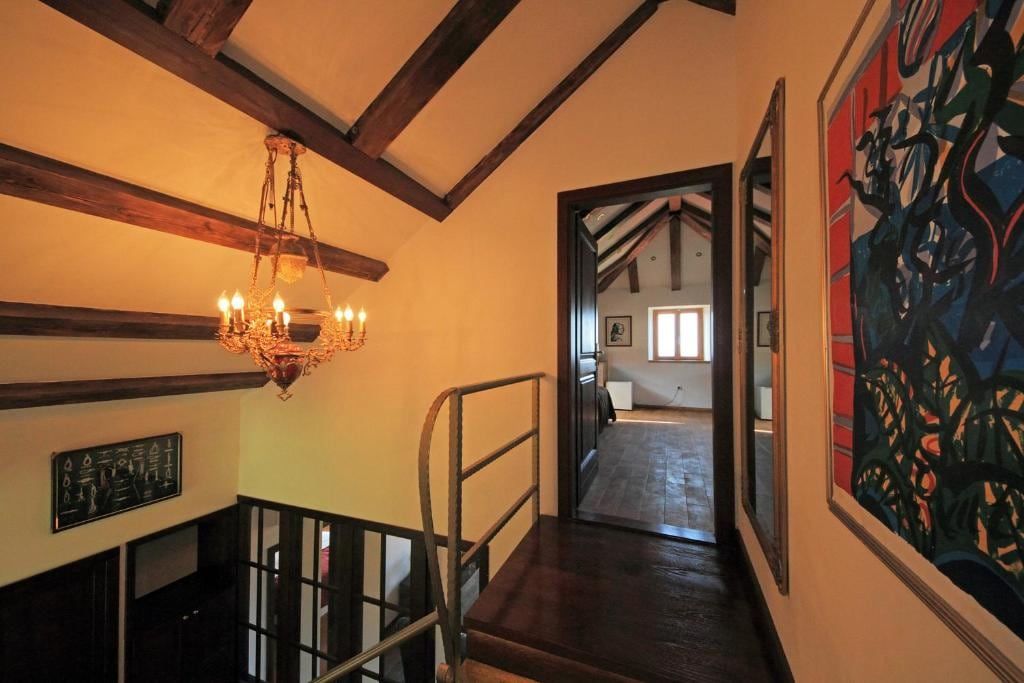 Upstairs hallway with wooden beams and a chandelier
